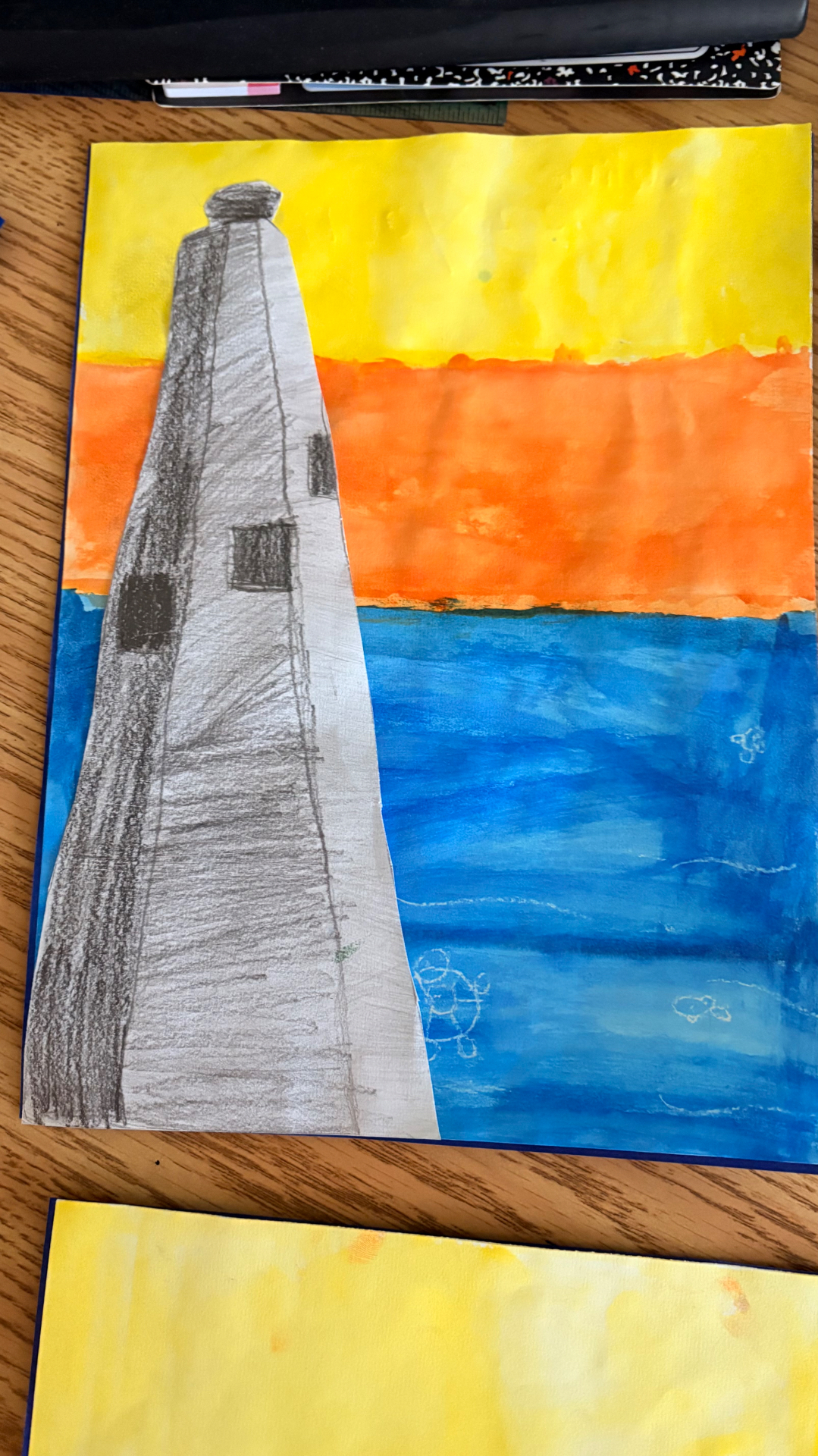 Tall lighthouse drawing set against a vivid ocean sunset
