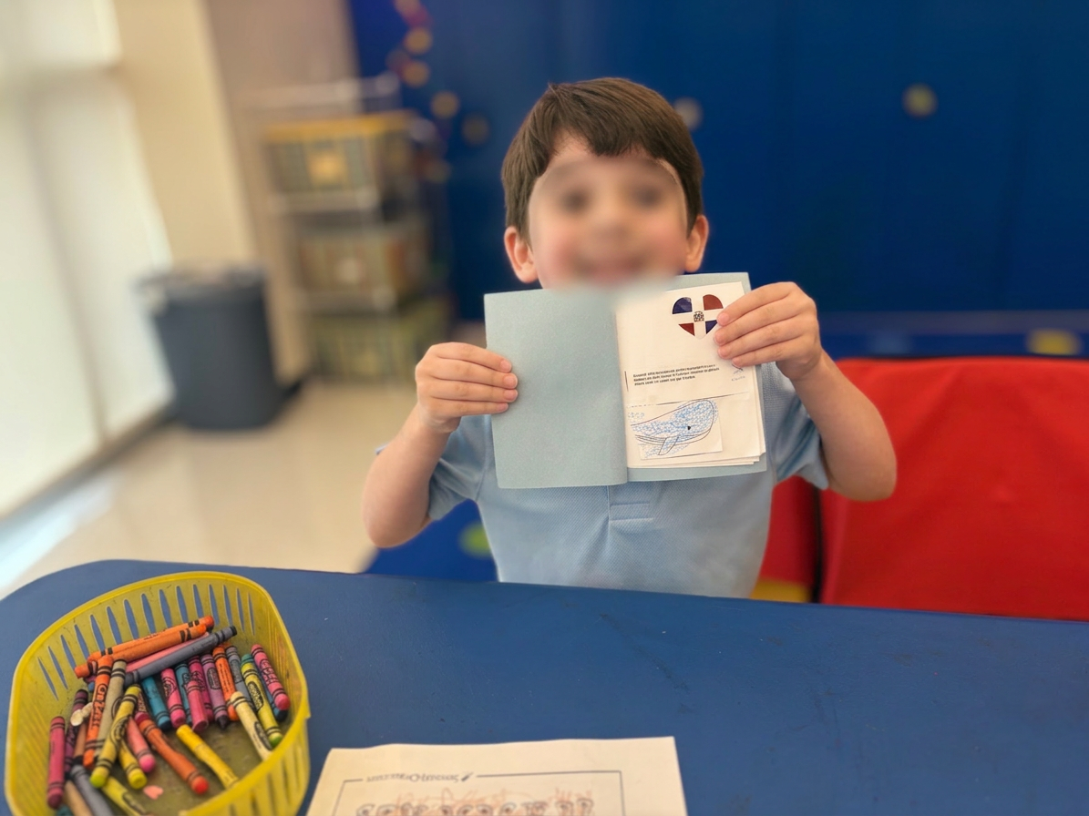 Proud little artist showing off a handmade booklet
