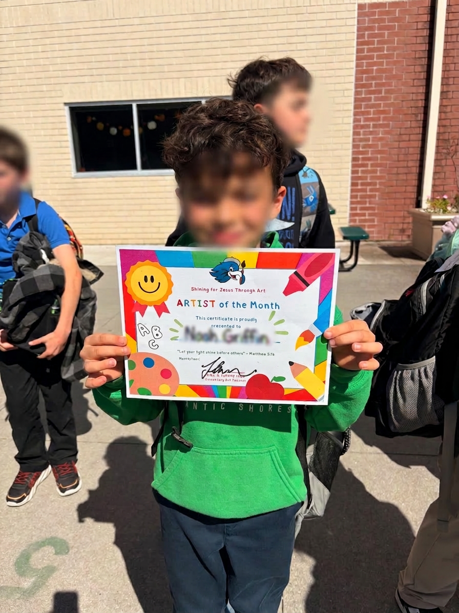 Artist of the Month showing off his certificate
