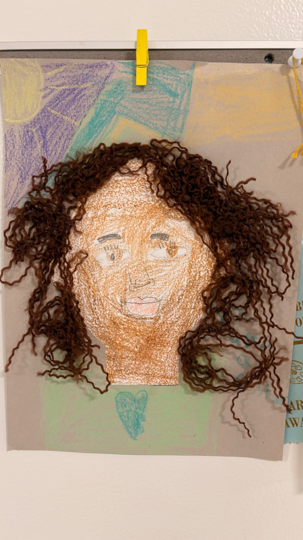 Mixed-media self portrait with curly yarn hair