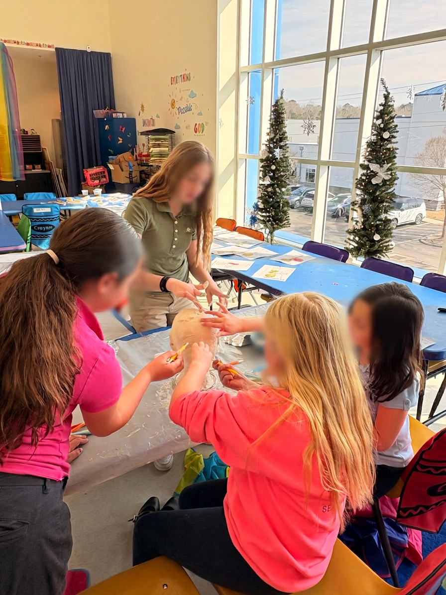 Students working together on a clay sculpture