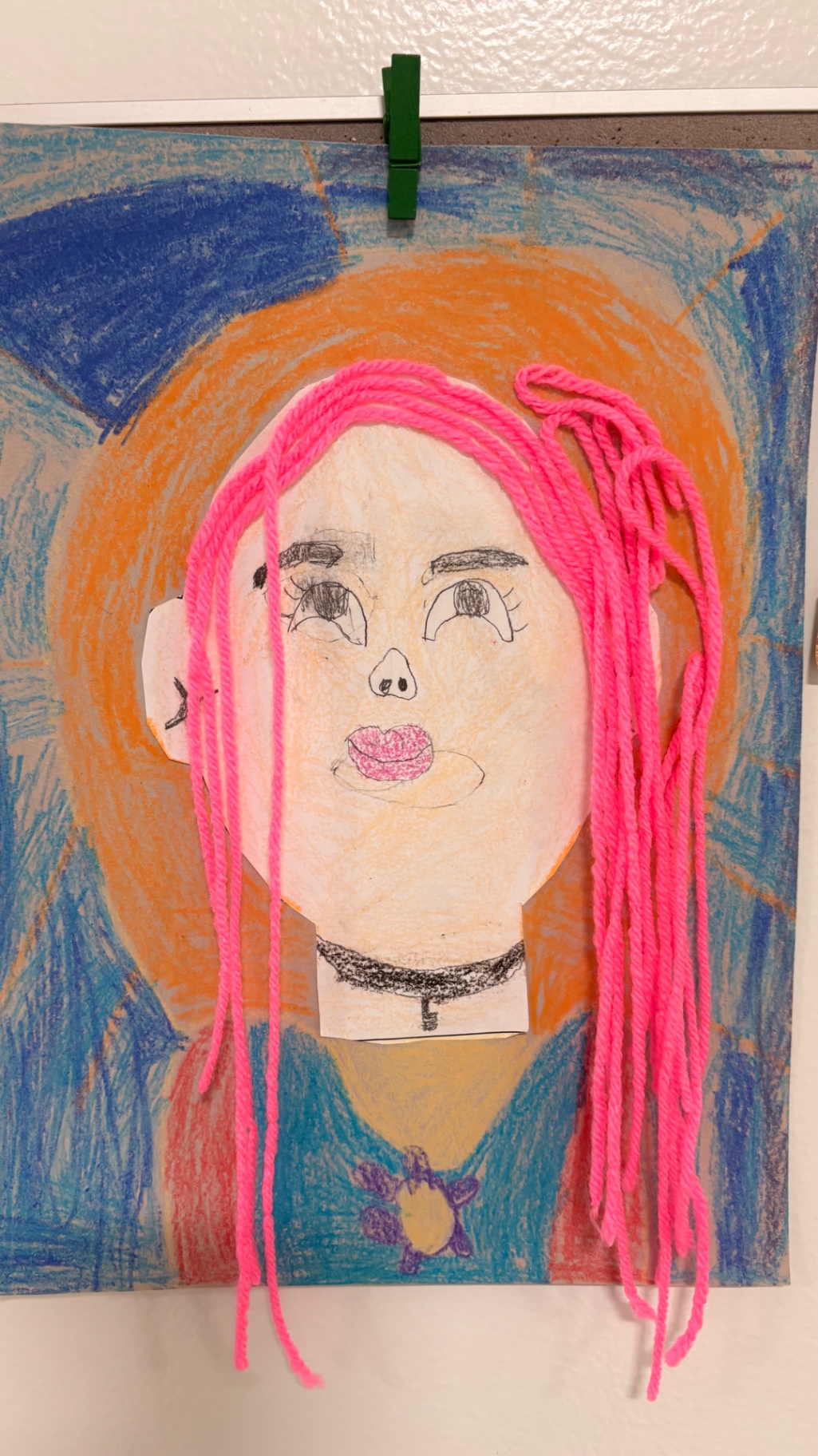 Mixed-media self portrait with bright pink yarn hair